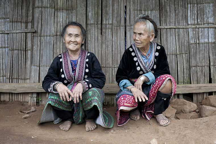 Två äldre kvinnor på huk i Mae Hong Son i Thailand